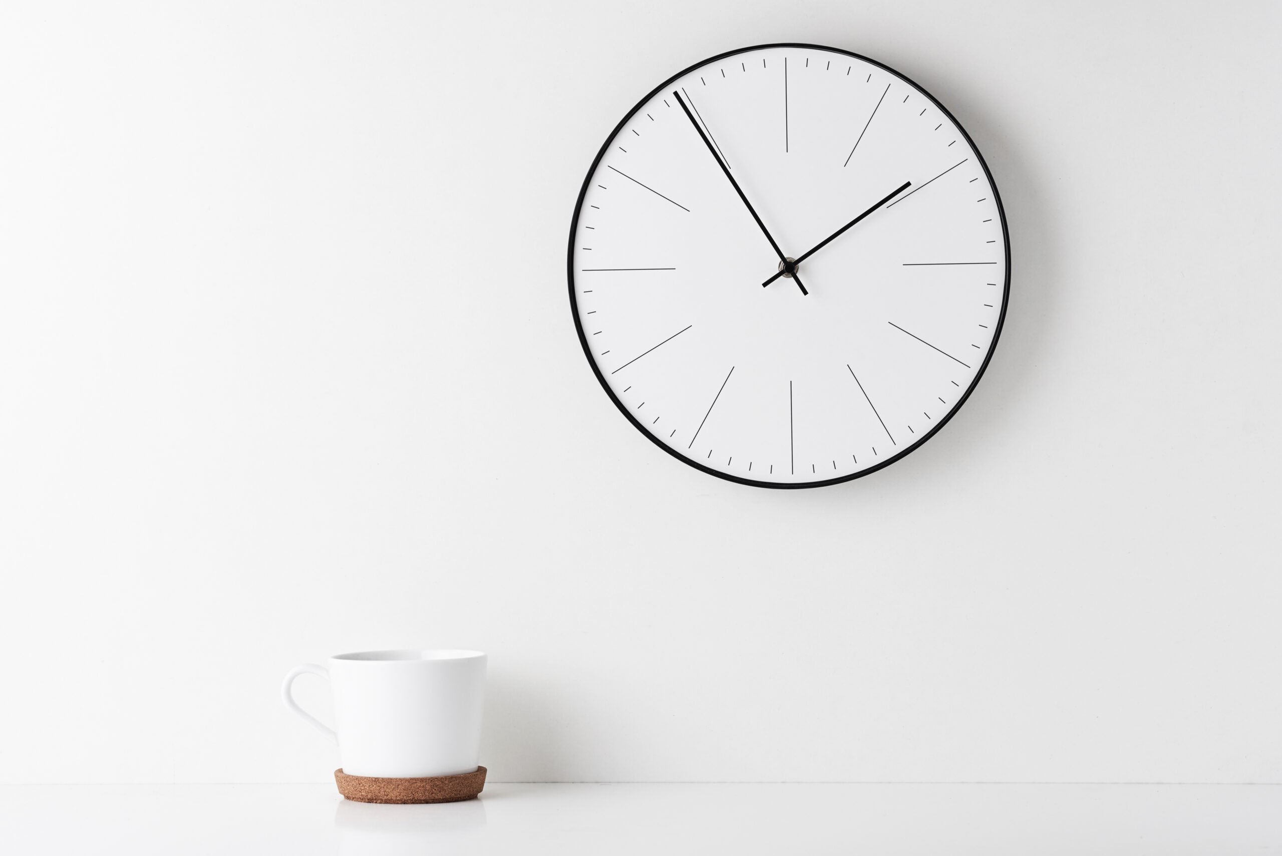 Close-up of a classic round clock on a wooden desk, symbolizing the anticipation of approaching labor and the countdown to childbirth